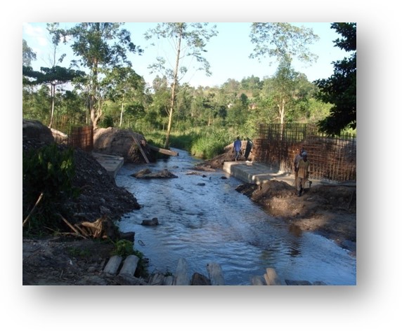 Nexus (U) Limited was entrusted with the construction of the Kanungu Bridge in Kanungu District, Uganda. This infrastructure project aimed to improve transportation, connectivity, and accessibility in the region, supporting economic development and improving the quality of life for local residents.  Scope of the Construction Work The construction of Kanungu Bridge involved several key phases, from initial planning and design to final execution, with a focus on ensuring the bridge's structural integrity and longevity.  Surveying and Design: The first phase of the project included detailed surveying of the site and designing a bridge structure that could withstand the region's environmental and traffic demands. The design process took into account local topography, hydrology, and soil conditions.  Foundation Work: The foundation of the bridge was carefully designed to ensure stability and safety, with deep foundations constructed to support the weight of the bridge and the traffic it would carry.  Bridge Deck and Superstructure: The bridge deck and superstructure were constructed using reinforced concrete and steel, materials chosen for their strength and durability. The deck was designed to accommodate vehicular traffic and pedestrian movement safely.  Piling and Pier Construction: Strong and reliable piling and piers were built to ensure the bridge’s stability over the water and provide resistance to environmental factors like flooding and erosion.  Approach Roads and Pavement: Nexus (U) Limited constructed the approach roads leading to the bridge, ensuring smooth connectivity with existing road networks. Proper paving and road signage were included for safe travel.  Safety and Security Features: Safety railings, guardrails, and other protective measures were installed to ensure the safety of drivers and pedestrians. Proper signage and lighting were also added to enhance visibility, especially during the night.  Environmental Considerations: Throughout the construction, Nexus (U) Limited implemented environmentally responsible practices, ensuring minimal disruption to local wildlife and ecosystems during the building process.  Final Inspection and Testing: After construction was completed, the bridge was thoroughly inspected to ensure compliance with safety and quality standards. Load testing and other necessary assessments were conducted before the official opening.  Benefits of the Kanungu Bridge Improved Accessibility: The completion of Kanungu Bridge has greatly improved transportation across the district, reducing travel time and connecting rural communities to nearby towns and cities.  Economic Development: The bridge facilitates easier access to markets, services, and resources, benefiting local farmers, businesses, and residents.  Enhanced Safety: The new bridge has provided a safer alternative to previous crossing methods, especially during rainy seasons when flooding and erosion were common concerns.  Community Connectivity: The bridge plays a crucial role in connecting Kanungu District to other parts of Uganda, promoting regional integration and supporting infrastructure development.  Completion and Outcome The Kanungu Bridge was successfully completed, with Nexus (U) Limited ensuring high standards of construction quality, safety, and environmental sustainability. The bridge now stands as a vital infrastructure asset, providing lasting benefits to the local community and supporting the broader development objectives of the region.